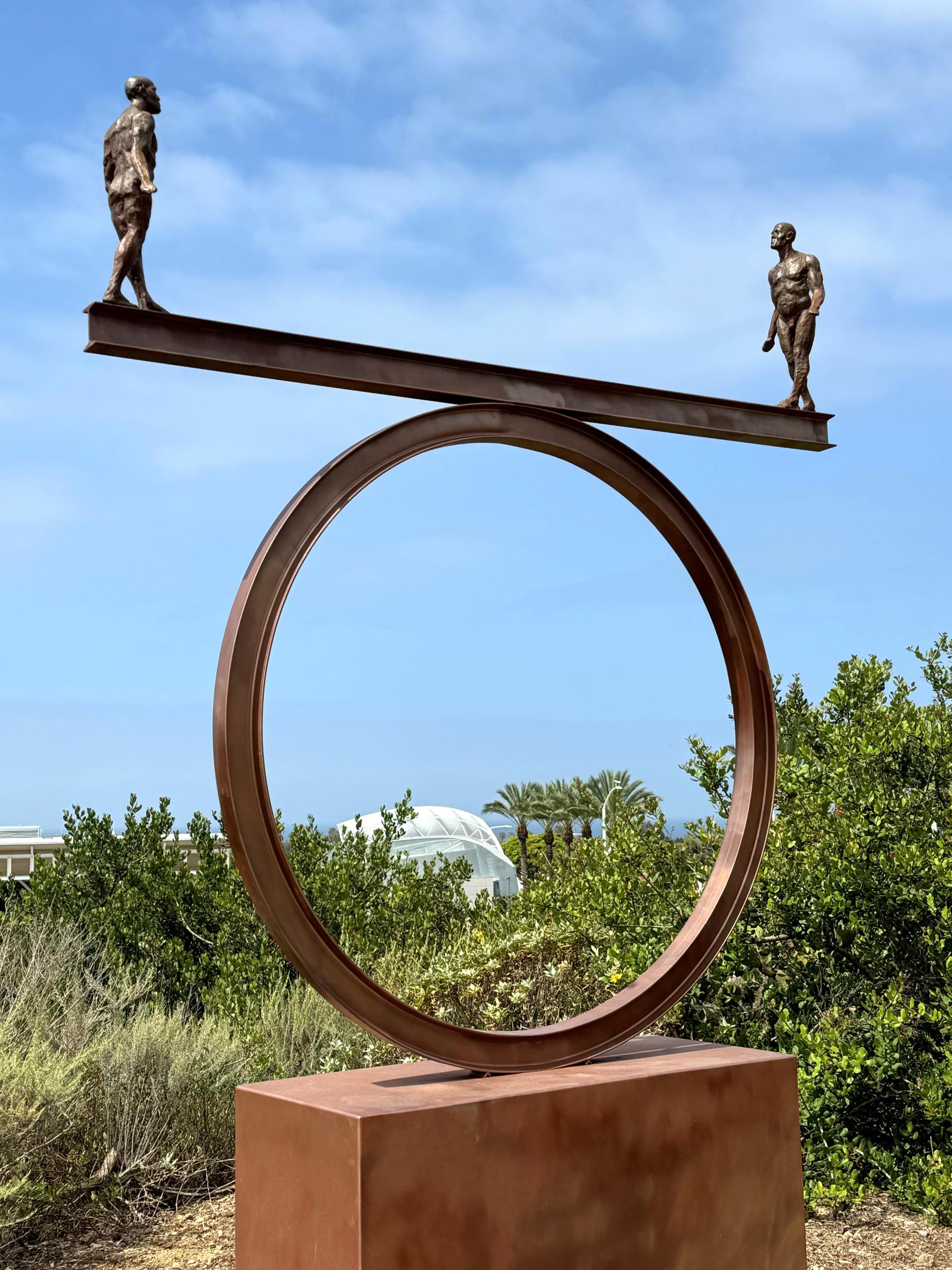 Sculpture of two figures balancing - sculpture in Civic Center Park