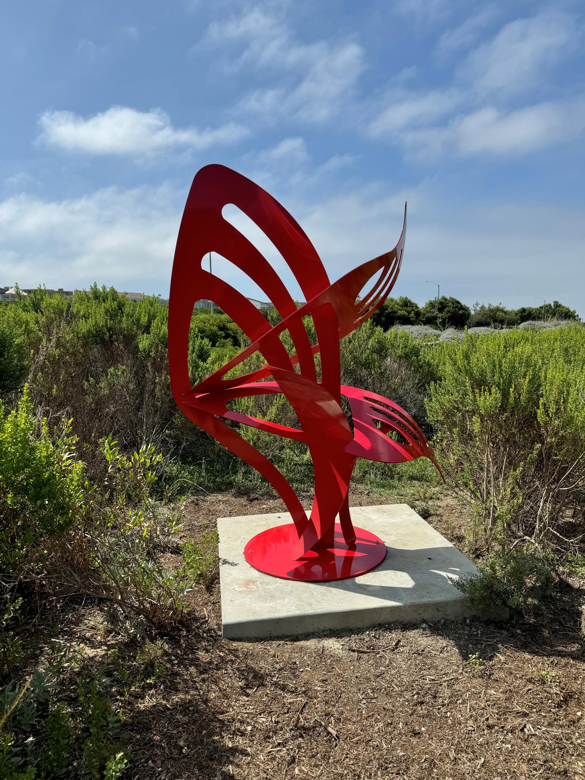 Red sculpture shaped like wings taking flight - sculpture in Civic Center Park