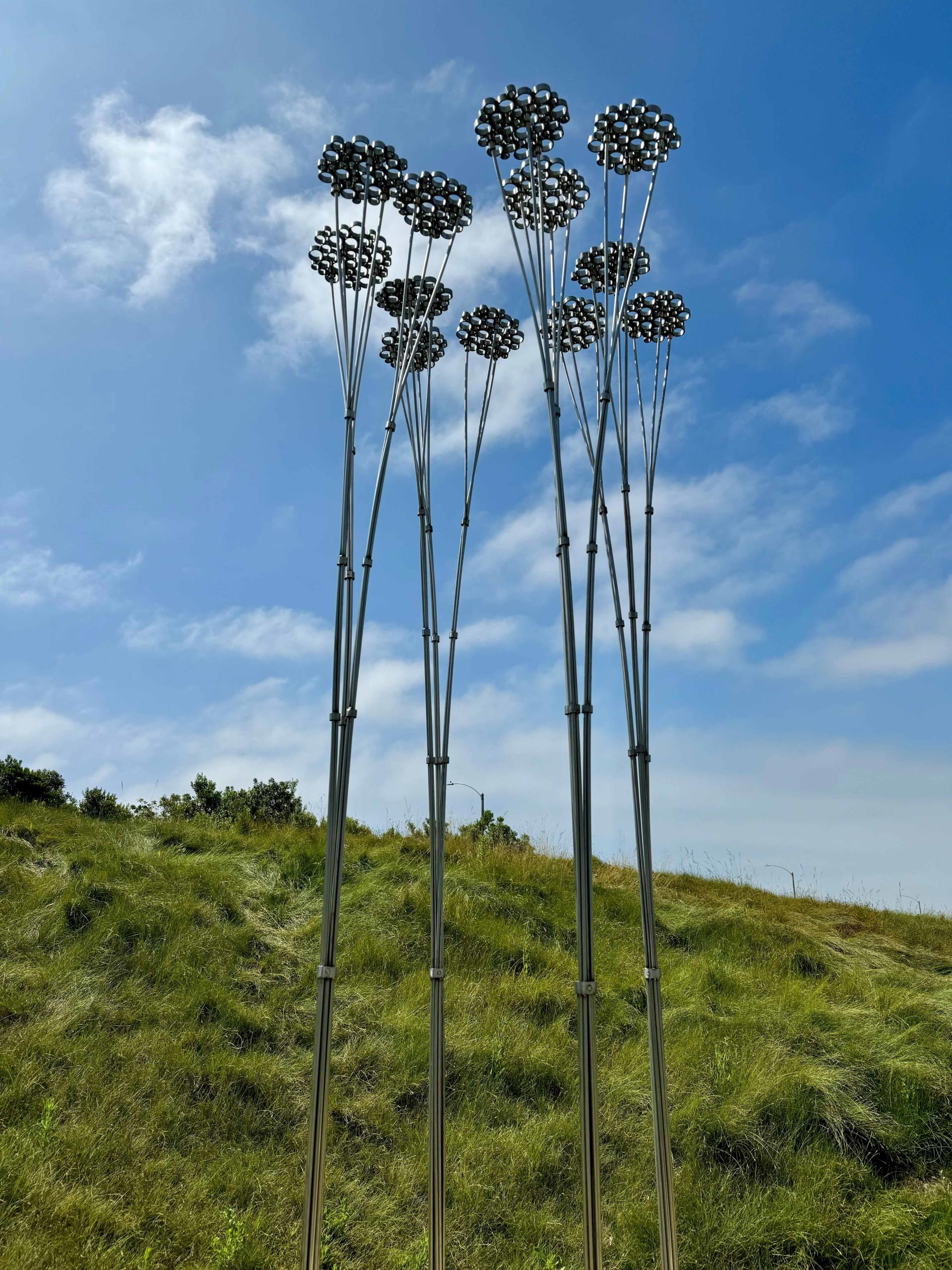 Sculpture of long thin poles and circular tops - sculpture in Civic Center Park