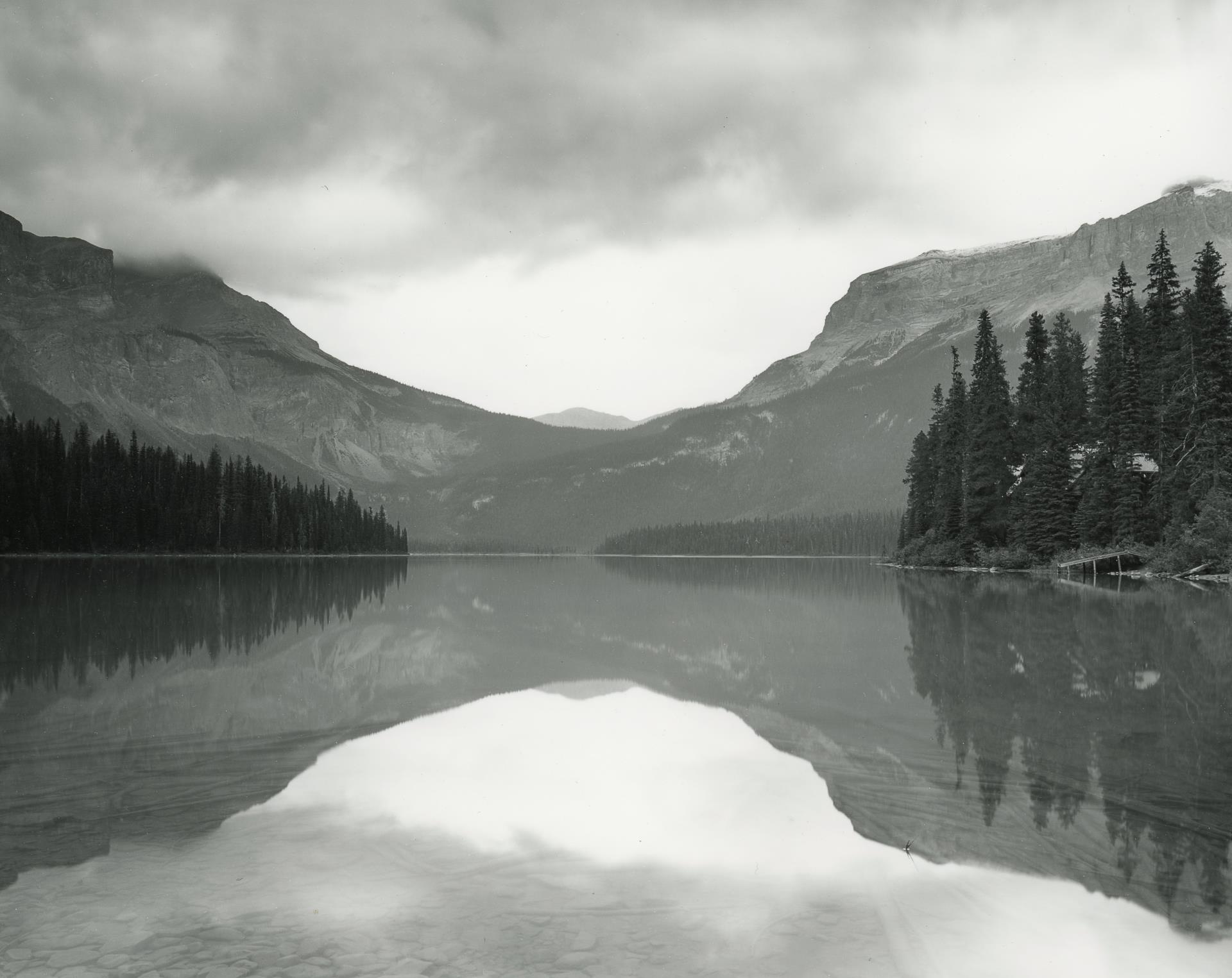 Photograph of a river, trees, and mountain in the background